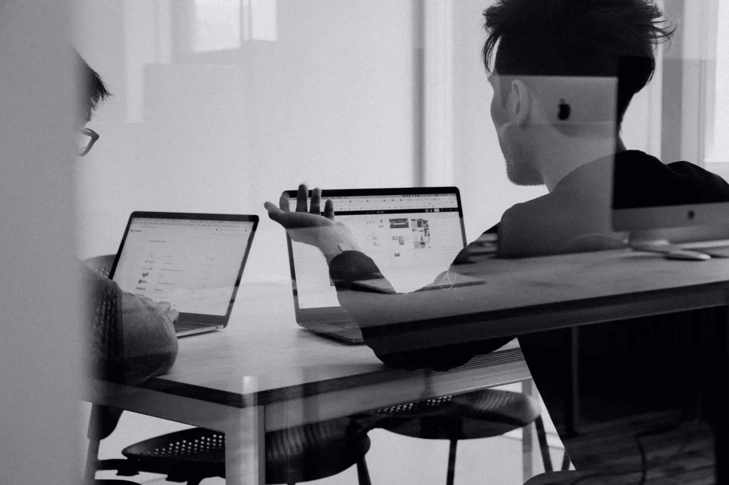 Image showing people discussing while looking at the laptop screen